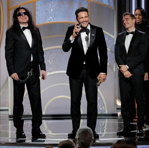 James Franco accepts his Golden Globe for his portrayal of Tommy Wiseau (also pictured on stage with Dave Franco) in Disaster Artist