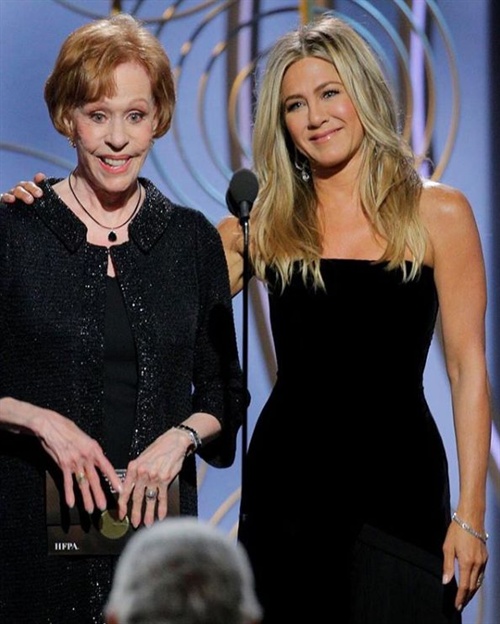 Jennifer Aniston in Schiaparelli tugged at Carol Burnett’s ear while presenting on stage