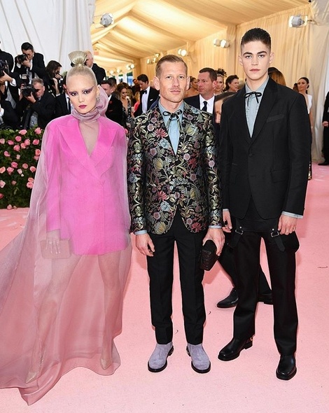 Pom Klementieff und Hero Fiennes-Tiffin in Ferragamo mit Designer Paul Andrew.